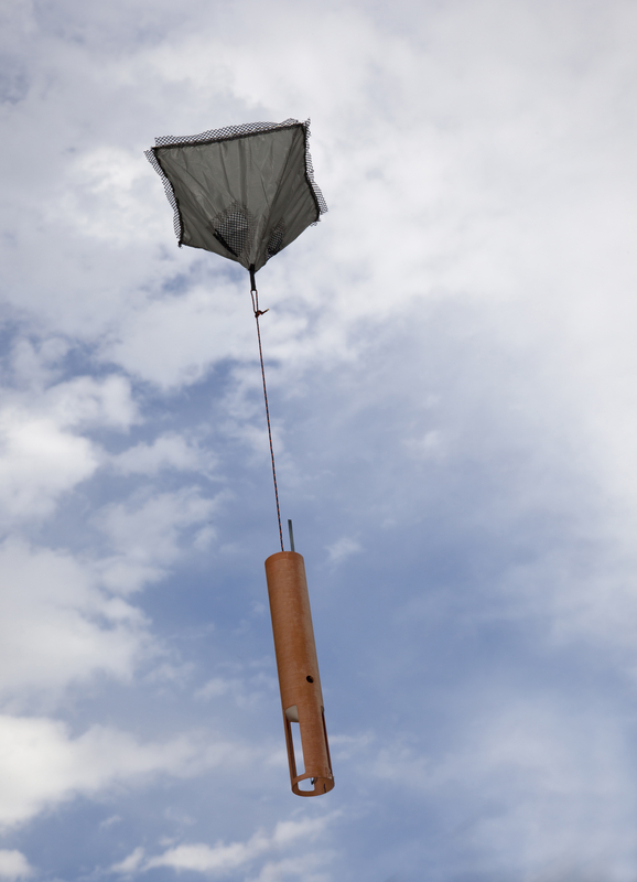 Image of dropsonde descending via parachute