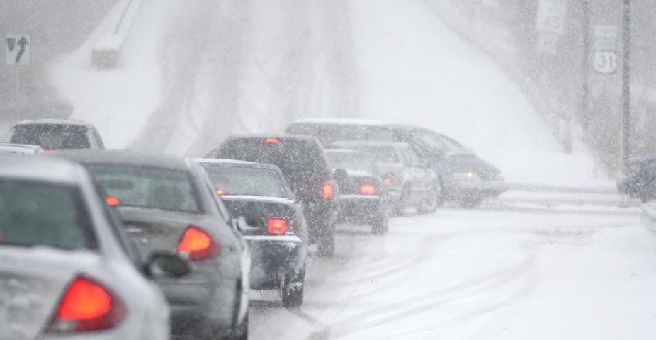 An accident waiting to happen, poor visibility, slick, snowy roads and lots of traffic, cars.