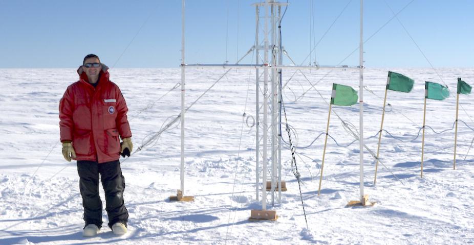RAL Scientist, Scott Landolt, standing next to a precipitation guage in Antarctica (photo courtesy of Scott Landolt, https://icechaser.blogspot.com).