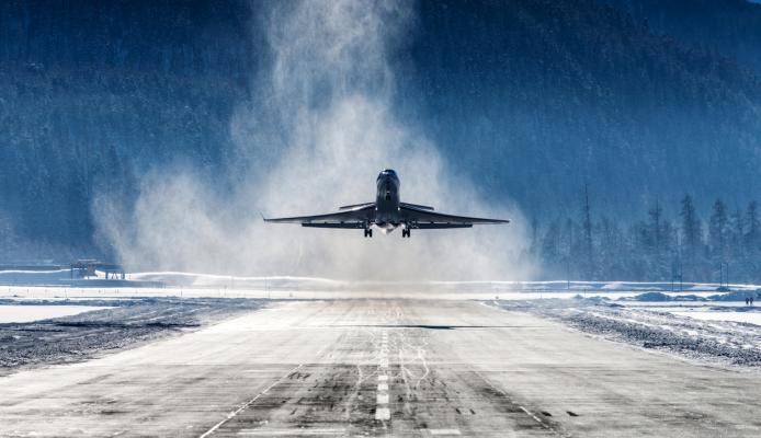 Business Jet departing a snowy airfield