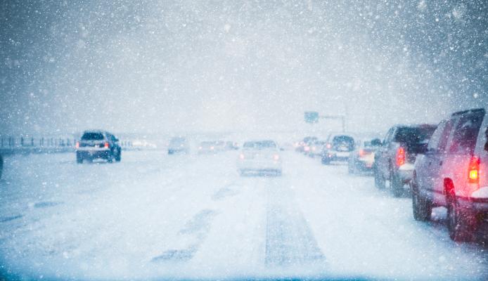 snowy highway with heavy traffic