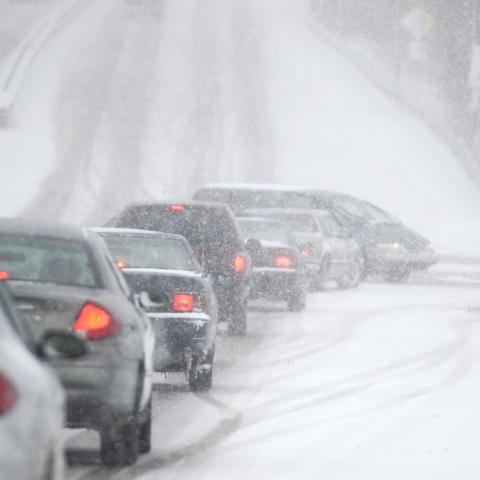 An accident waiting to happen, poor visibility, slick, snowy roads and lots of traffic, cars.