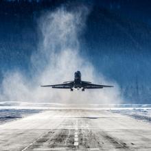 Business Jet departing a snowy airfield